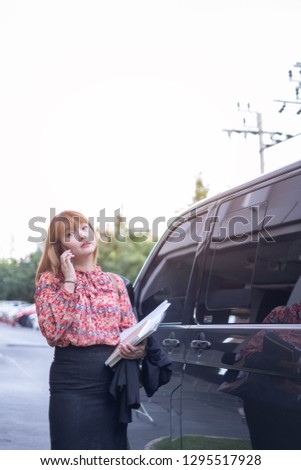 An Asian businesswoman walking in a direct sunlight. This portrait picture can be used in such concept as sunscreen, sun cream, spf50, PA+++, beauty, sun protection, confidence and so on. 