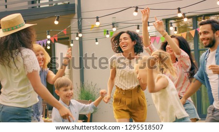 Family and Friends Dancing together at the Garden Party Celebration. Young and Elderly People Having Fun on a Sunny Summer Day Disco. Royalty-Free Stock Photo #1295518507