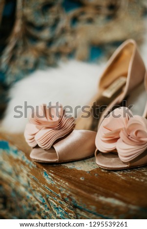 
Beautiful picture for a wedding article or wedding site. Bride's shoes and cape on a wooden chair.