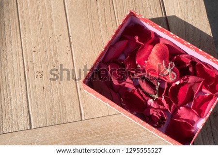 Valentine's Day greeting card. Top view on romantic composition with gift box copy space on wooden background