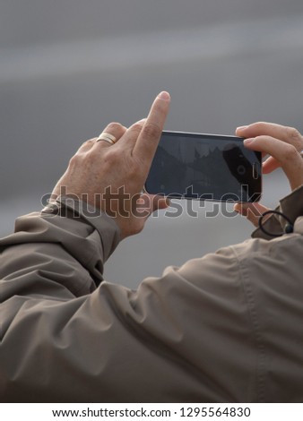 A tourist taking pictures with a smartphone in Copenhagen, Denmark