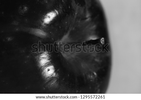 Macro photo of a Red Delicious apple. Beautiful closeup shows the details of this fruit. Black and white photo.