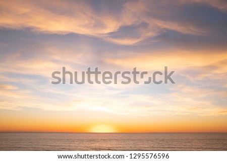 Scenic Ocean Sunset Royalty-Free Stock Photo #1295576596