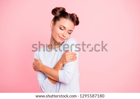 Portrait of nice-looking sweet lovable attractive winsome fascinating well-groomed lovely calm peaceful cheery girl hugging herself isolated over pink pastel background Royalty-Free Stock Photo #1295587180