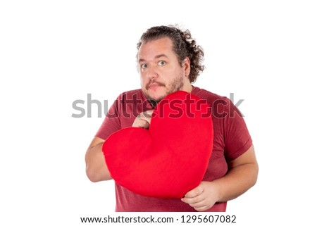 A studio shot of a fat man holding a red heart shaped pillow isolated on white background