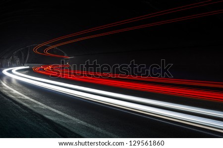 Car light trails in the tunnel. Art image . Long exposure photo taken in a tunnel