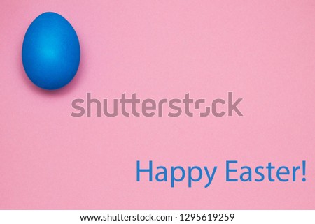 Blue Easter egg on pink background