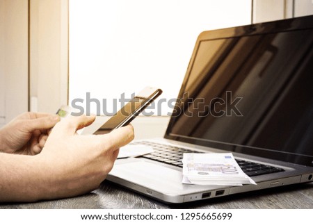 Photo businessman working with generic design notebook. Online payments, banking, hands keyboard. Businessman holding smartphone in hand and credit card