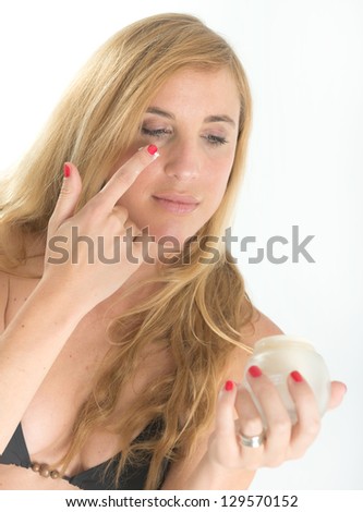 Girl in beachwear applying suntan lotion