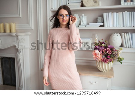 the girl wearing spectacles on a light background