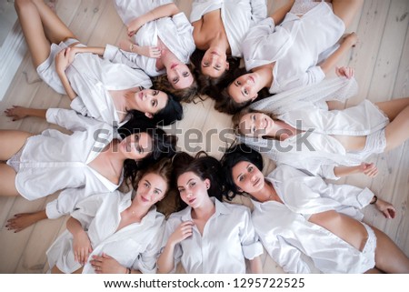 happy girls in white men's shirts that celebrate a bachelorette party 