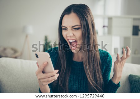 Closeup photo portrait of angry aggressive crazy unsatisfied holding looking at screen monitor she her lady wearing green casual pullover sweater