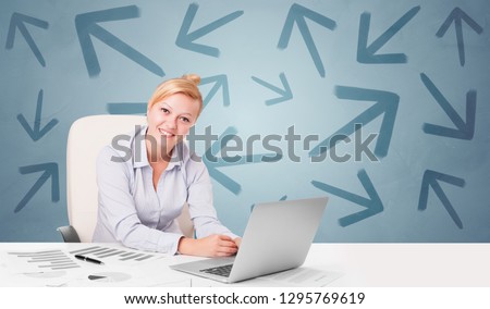 Business person sitting at desk with different direction concept