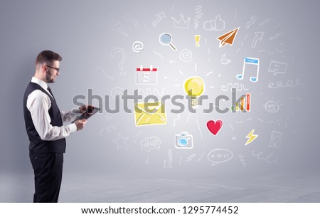 Young manager presenting new plan  illustrated by colourful chalk drawn icons and symbols around