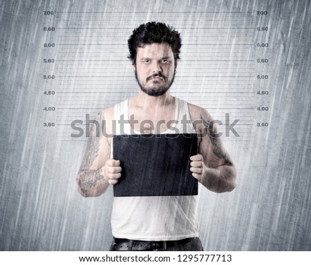 Gangster with rainy, lowering background and table on his hand.