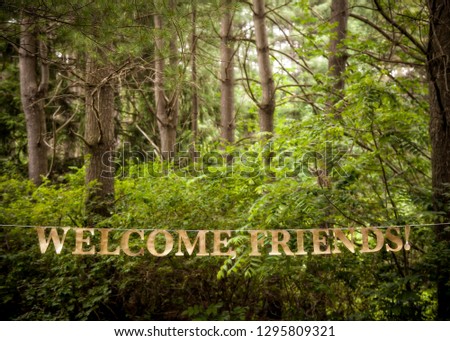 Green forest, welcome friends, hanging sign, celebration, event, trees, horizontal