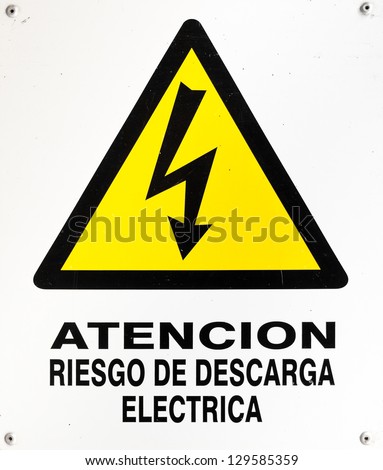 Sign of warning for high voltage or "atencion riesgo de descarga electrica" in spanish. This is a photo of a real sign and it is not intended to be an isolation. The white on it is not blown.
