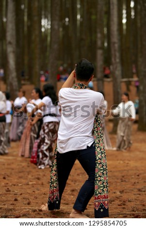 A young man is practicing Javanese traditional dance in the open