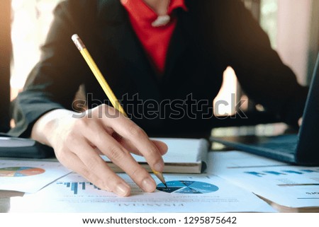 Close up of Business woman investment consultant analysis company annual financial report balance sheet statement working with documents graphs. Concept picture of economy, marketing