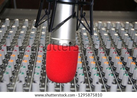 Professional microphone and audio mixer in radio  studio.