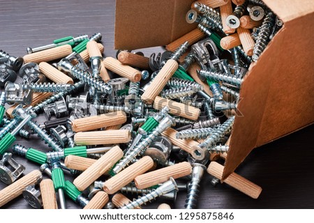 Open box with fall out tools for furniture assembly, closeup