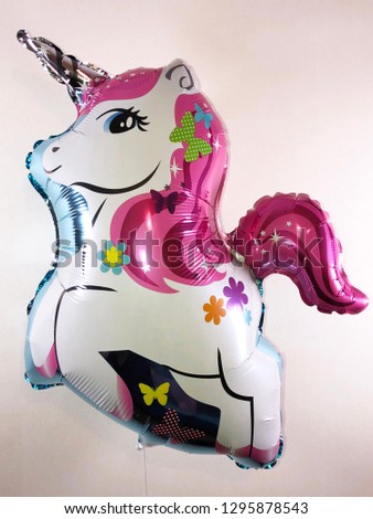 Balloon in the form of a fairytale character of a white and pink unicorn
