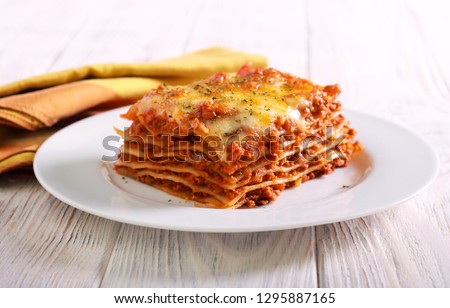 Slice of lasagna  on plate selective focus Royalty-Free Stock Photo #1295887165