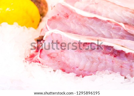 Fresh chilled out fillets of white fish on the counter of ice. fresh food.