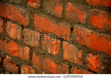 A freshly made brick wall with the mortar of cement, sand and water, selective focusing