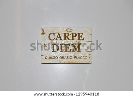plaque with the Latin carpe diem the words of Horace meaning seize the day or make the most of the moment