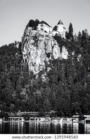 Bled castle on the high rock with lake, Slovenia. Travel destination. Beautiful scene. Tourism theme. Black and white photo.