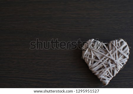 white wicker heart on wooden background.Valentine's day concept . Copy space. Card.