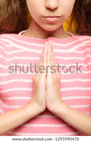 namaste mudra. cropped shot of girl hands in greeting gesture. yoga practice for children concept.