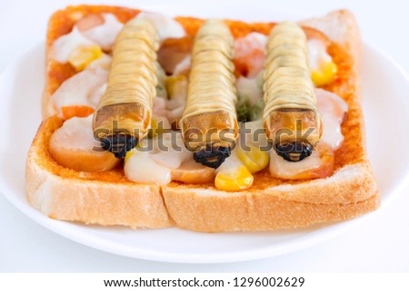 Food Insects: Worm beetle or Witchetty grub for eating as food items made of cooked insect meat on bread baked sandwich on plate, it is so rich in protein edible and delicious. Entomophagy concept.