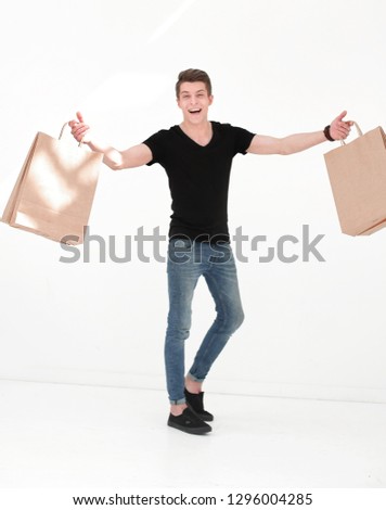 Smiling young man carrying shopping bags