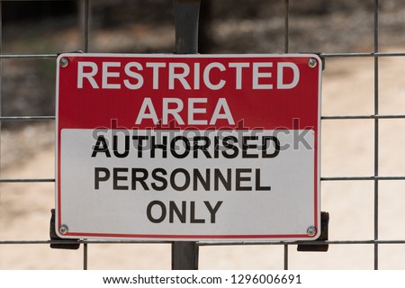 Restricted Area, Authorised Personnel Only  - safety warning sign for not trespassing on blurred background Royalty-Free Stock Photo #1296006691