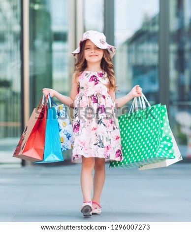 Cute little girl on shopping. Portrait of a kid with shopping bags. Shopping. girl.