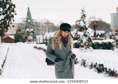 Happy woman warmly clothed  in winter in the street 