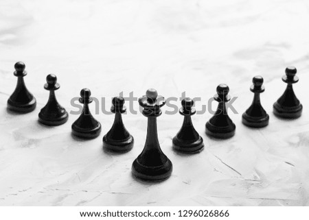Black king with pawns. Leader business concept. Black and white photography