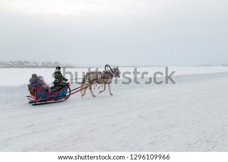 Winter holiday New Year's (Christmas) sleigh rides harnessed by horses (sledding) along the embankment of Veliky Ustyug