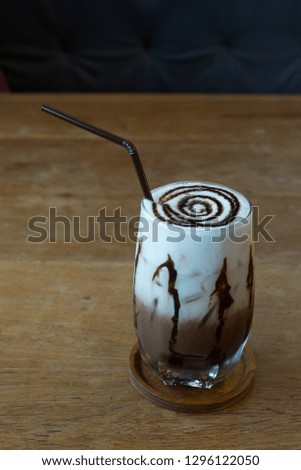 Delicious cold cappuccino placed on a wooden table