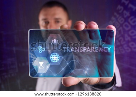 The concept of business, technology, the Internet and the network. A young entrepreneur working on a virtual screen of the future and sees the inscription: Transparency