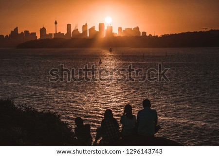 People watching the sunset over the Sydney skyline
