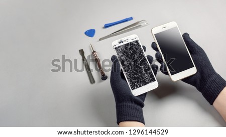 Technician or engineer preparing to repair and replace new screen broken and cracked screen smartphone preparing on desk with copy space Royalty-Free Stock Photo #1296144529