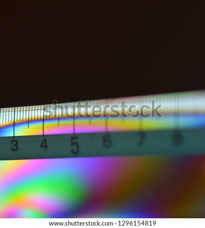 Multicolored school measuring ruler with centimeters on black background
