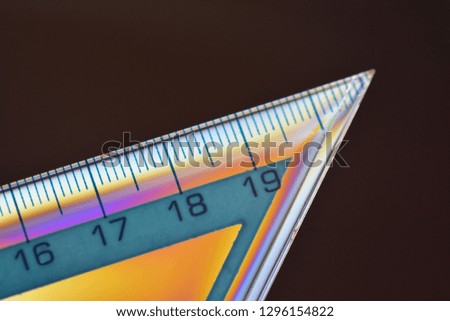Multicolored school measuring ruler with centimeters on black background