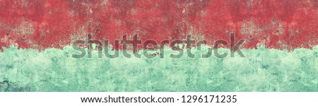 Old shabby blue concrete wall texture with cracked red paint. Wide grunge panoramic background