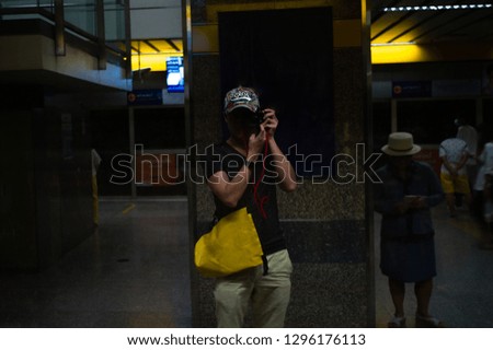 Portrait of unidentified man taking himself a picture reflection with the mirror
