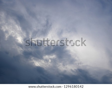 Dark and light bluish tragic cloudscape with various density chaotic thunderclouds