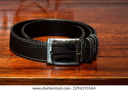 Leather  belt on wooden floor. vintage picture 